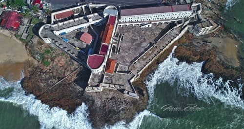 Place to See - An aerial view of Cape Coast Castle and the shoreline where the ships would arrive to collect the slaves.